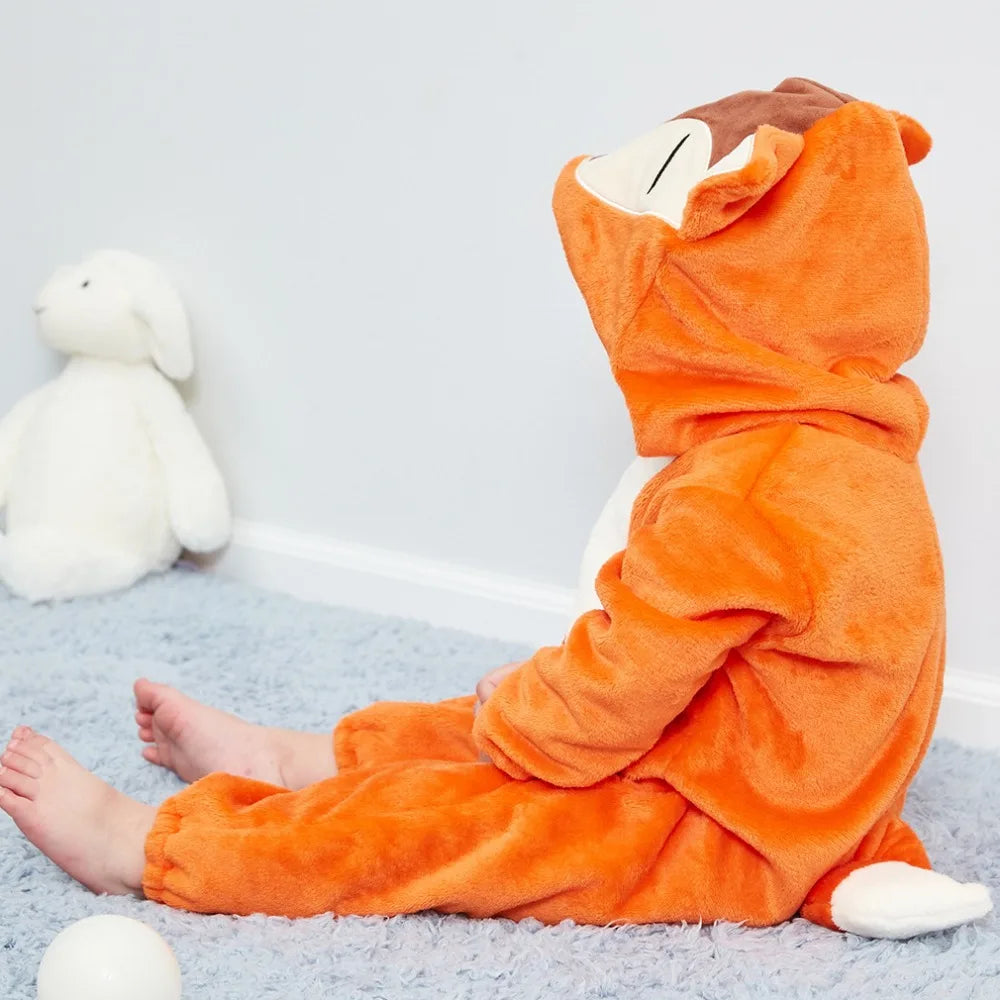 An adorable orange hooded romper for a baby lying on a light blue rug.