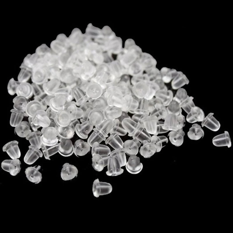 A pile of clear silicone earring backs for jewelry making.