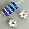 A string of blue crystal rondelle spacer beads for jewelry making, along with two separate silver-toned bead caps.
