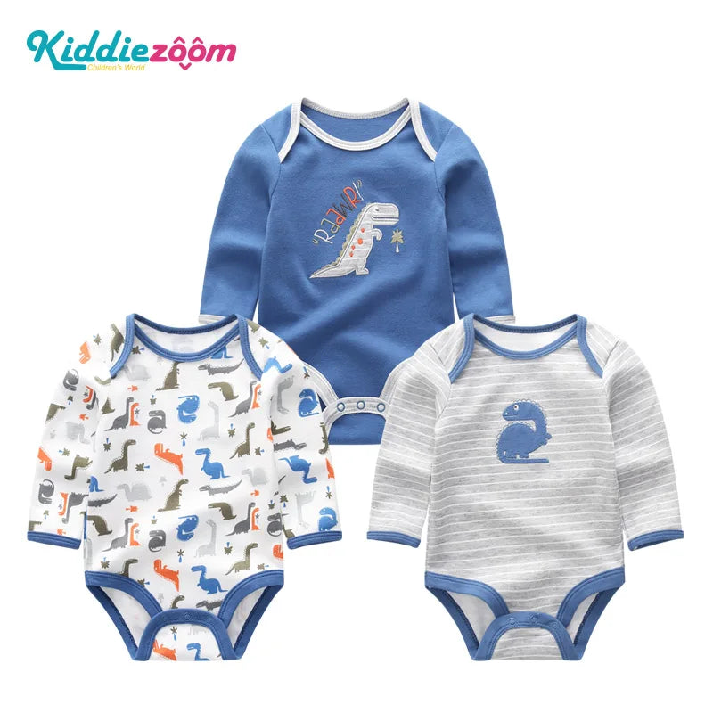 A set of three cotton baby bodysuits with long sleeves featuring dinosaur designs in blue and gray.