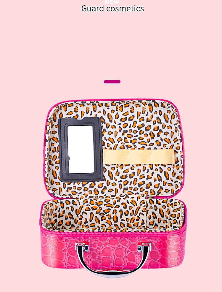 A pink leopard print makeup set with a mirror and storage compartment for kids.