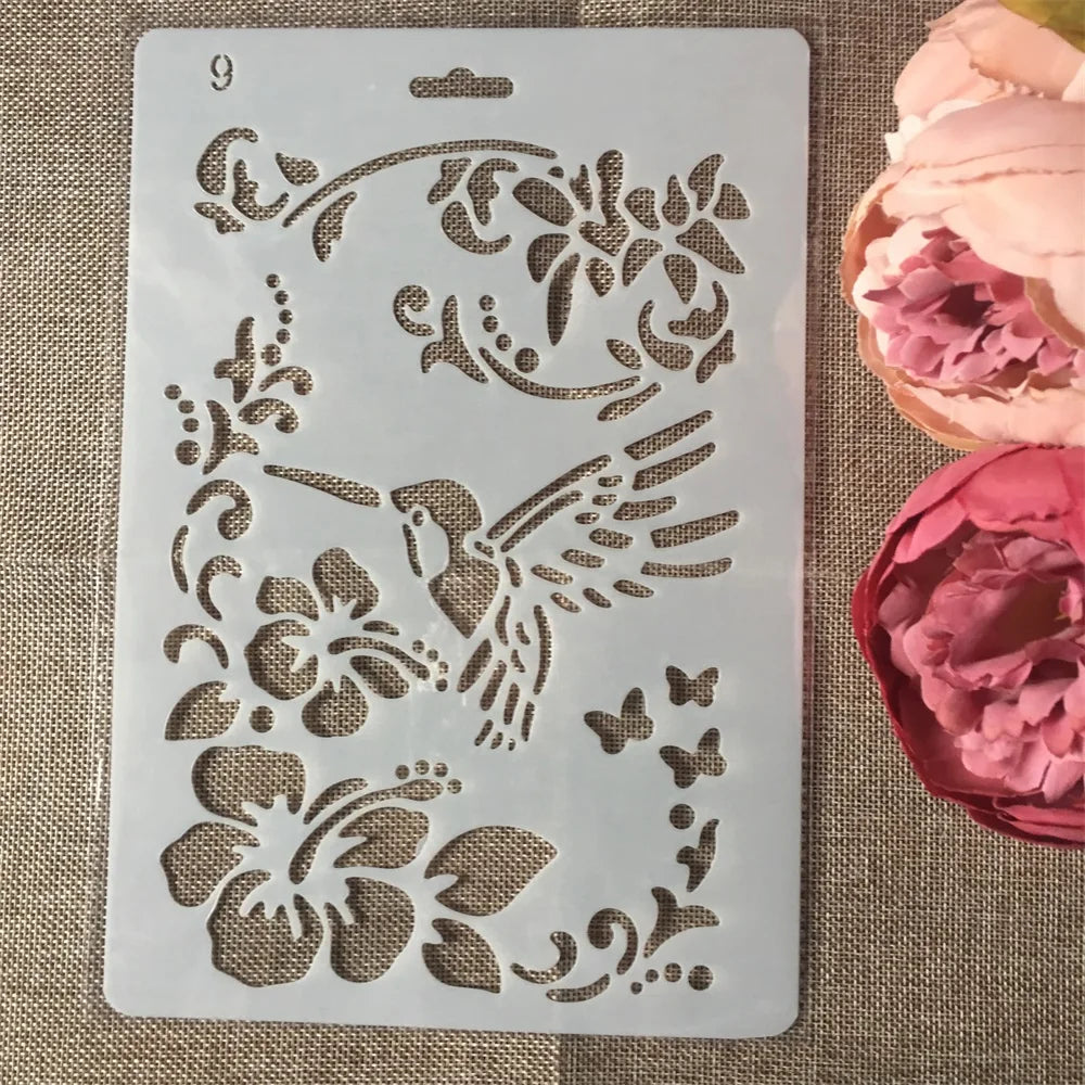A white stencil with floral and bird designs is shown next to pink and magenta rose petals.