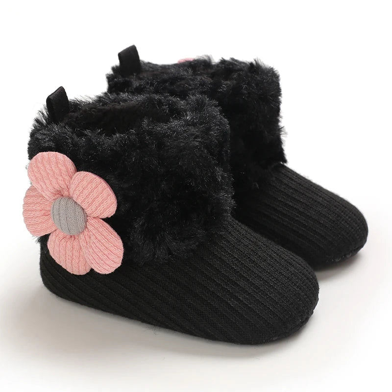 Black faux fur baby snow boots for girls and boys with a pink flower detail