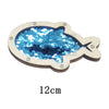 A wooden fish-shaped sensory learning toy with blue sequins for toddlers.