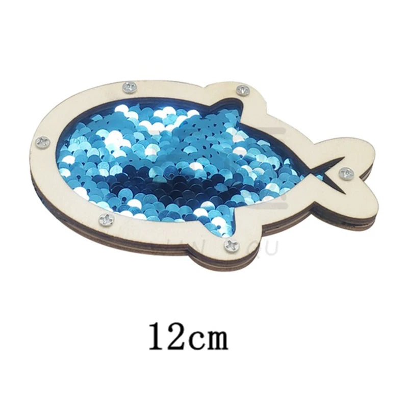 A wooden fish-shaped sensory learning toy with blue sequins for toddlers.