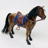 A 1/12 scale dollhouse horse with a brown coat wearing a brown leather saddle and riding prop.