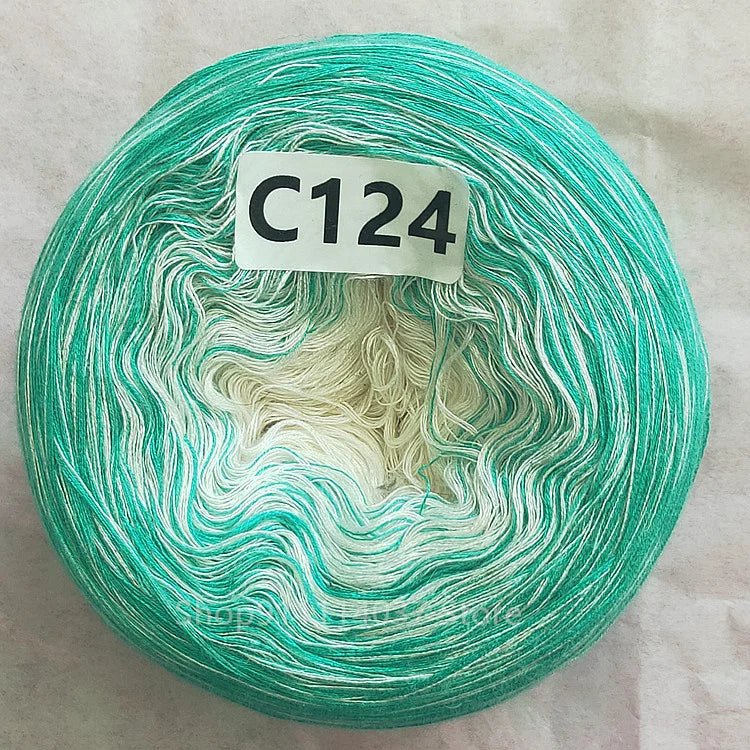 A spool of teal green and white yarn labeled C124, used for knitting or crochet projects.