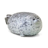 A gray and white plush toy shaped like a chubby seal with a smiling expression.