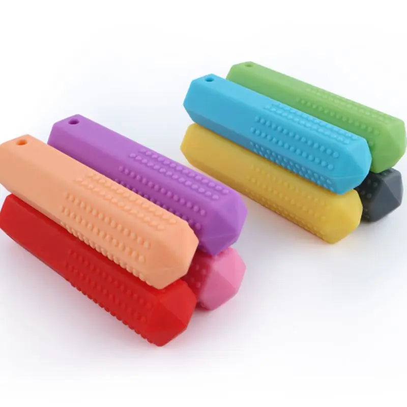 A collection of colorful silicone chew necklaces in shades of purple, orange, red, green, and blue.