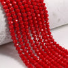 A close-up of a strand of bright red faceted crystal glass beads for jewelry making