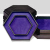 A hexagonal dice tray and storage box with a dark exterior and a vibrant purple velvet interior.