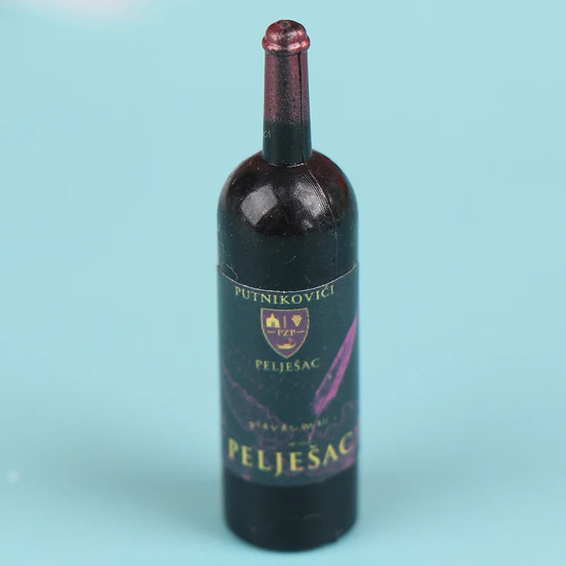 A dark glass bottle of Pelješac wine with a cork, labeled Putnikovici and Pelješac.