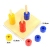 A set of wooden Montessori sensory toys featuring colorful cylinders and dowels in yellow, blue, and red.
