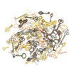 A collection of vintage metal key charms and antique keys in various brass, silver, and bronze tones.