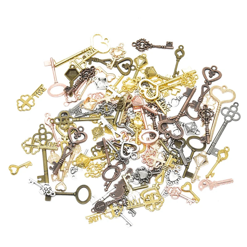 A collection of vintage metal key charms and antique keys in various brass, silver, and bronze tones.