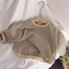 A beige and black striped kids cotton pullover sweatshirt hanging on a wooden hanger against a white background.