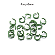 A pile of Army Green metal open jump rings for DIY jewelry making.