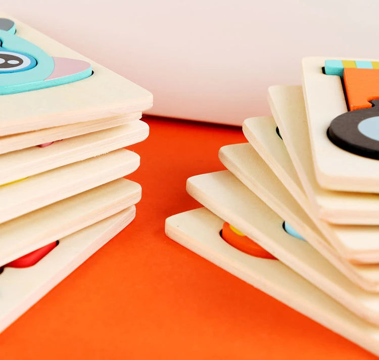 A stack of wooden puzzle pieces shaped like cartoon animals in various colors on an orange surface.