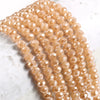 A string of faceted, light amber crystal glass beads for jewelry making
