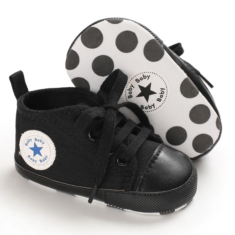 Black canvas baby shoes with white polka dot soles and stars