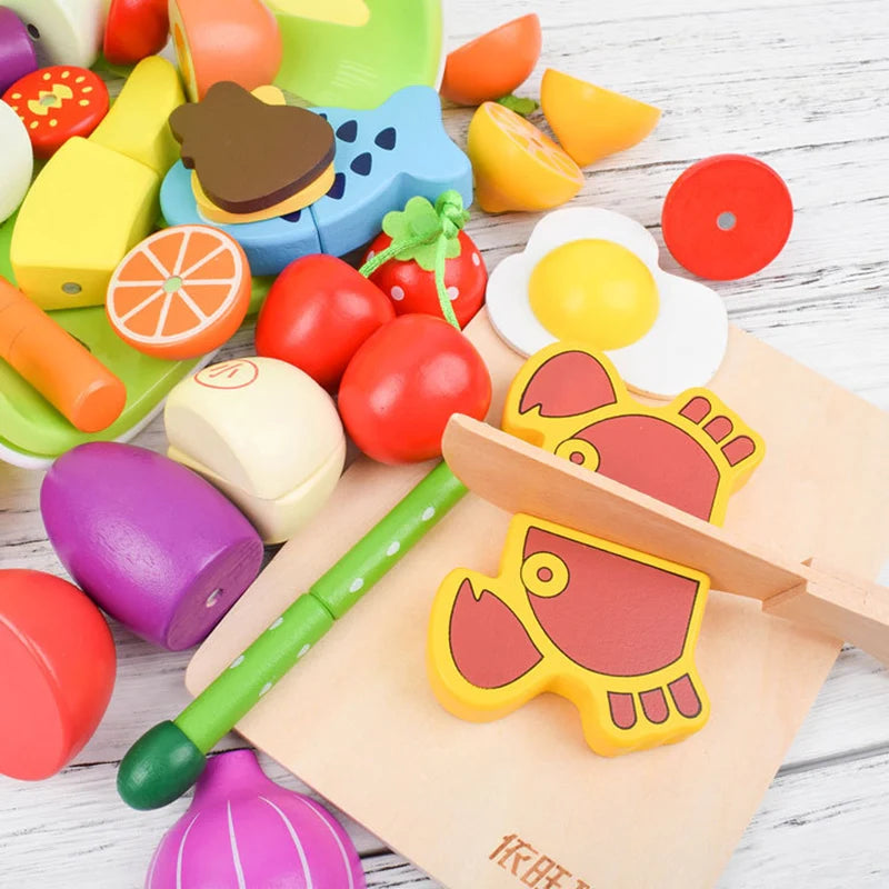 A set of magnetic wooden fruit and vegetable cutting toys in various colors like red, yellow, green, and purple.