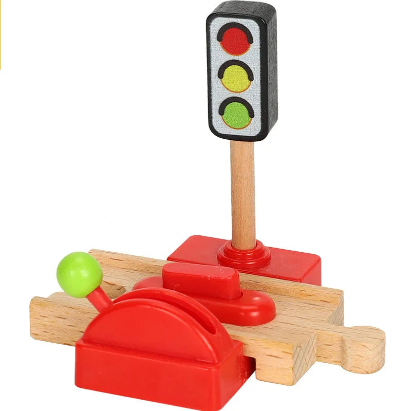 A wooden train track accessory set featuring a traffic light and a gas station pump model.