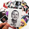 A hand holds a white card featuring a black and white portrait of Lil Peep with tattoos and the word daddy.