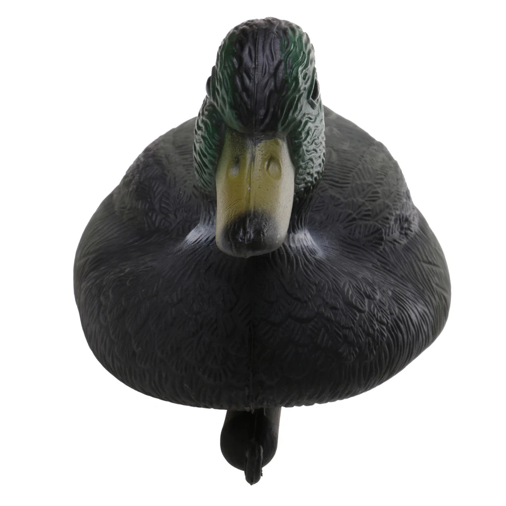 A black duck decoy with a green head and yellow eye, shown from above.