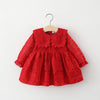 A red lace princess dress for a toddler girl with a doll collar, hanging on a wooden hanger.