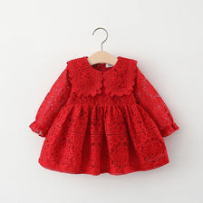 A red lace princess dress for a toddler girl with a doll collar, hanging on a wooden hanger.