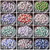 A grid of 12 glass bowls filled with various colors and patterns of floral ceramic beads for jewelry making