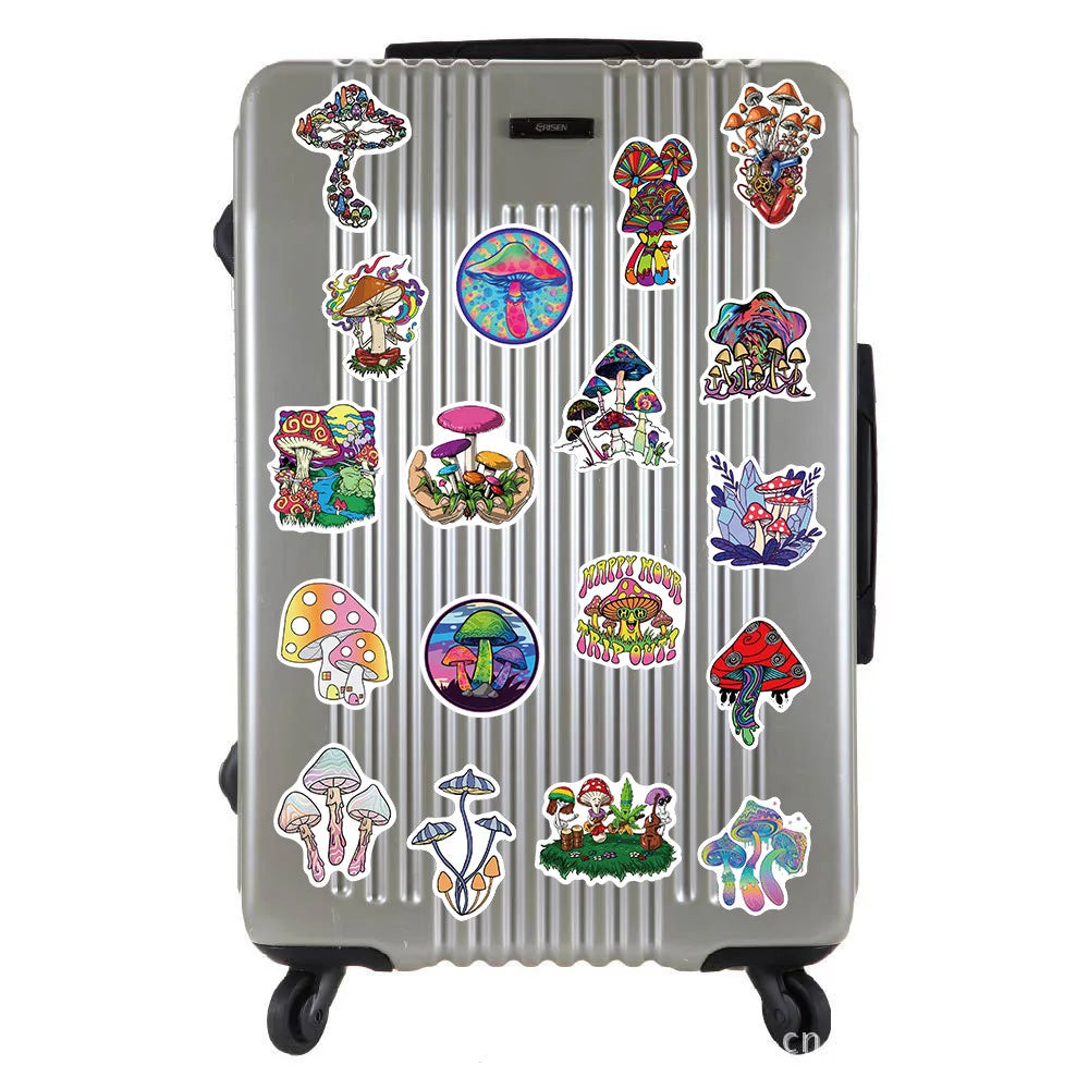 A silver suitcase decorated with various psychedelic mushroom vinyl stickers.