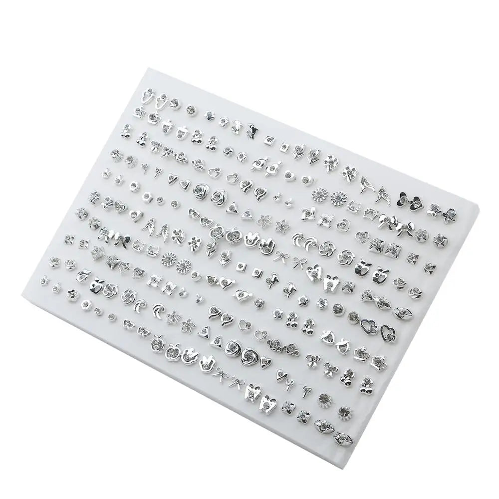 A collection of assorted acrylic stud earrings featuring hearts, stars, and moons arranged on a white display card.