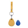A tan leather key wallet with a hanging loop and a blue tag is shown against a white background.