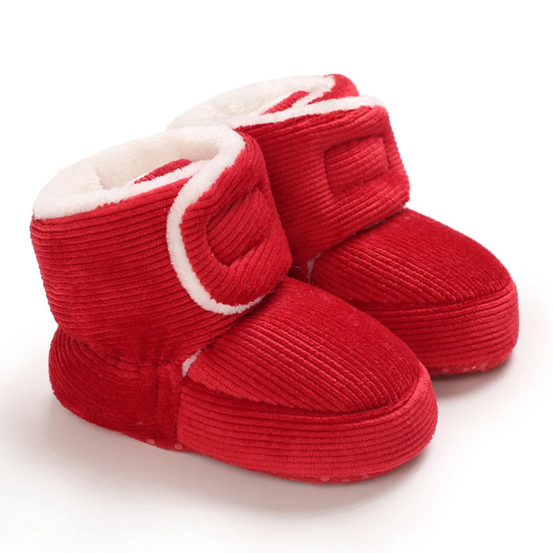 Pair of red knitted baby first walker shoes with white trim and faux fur lining