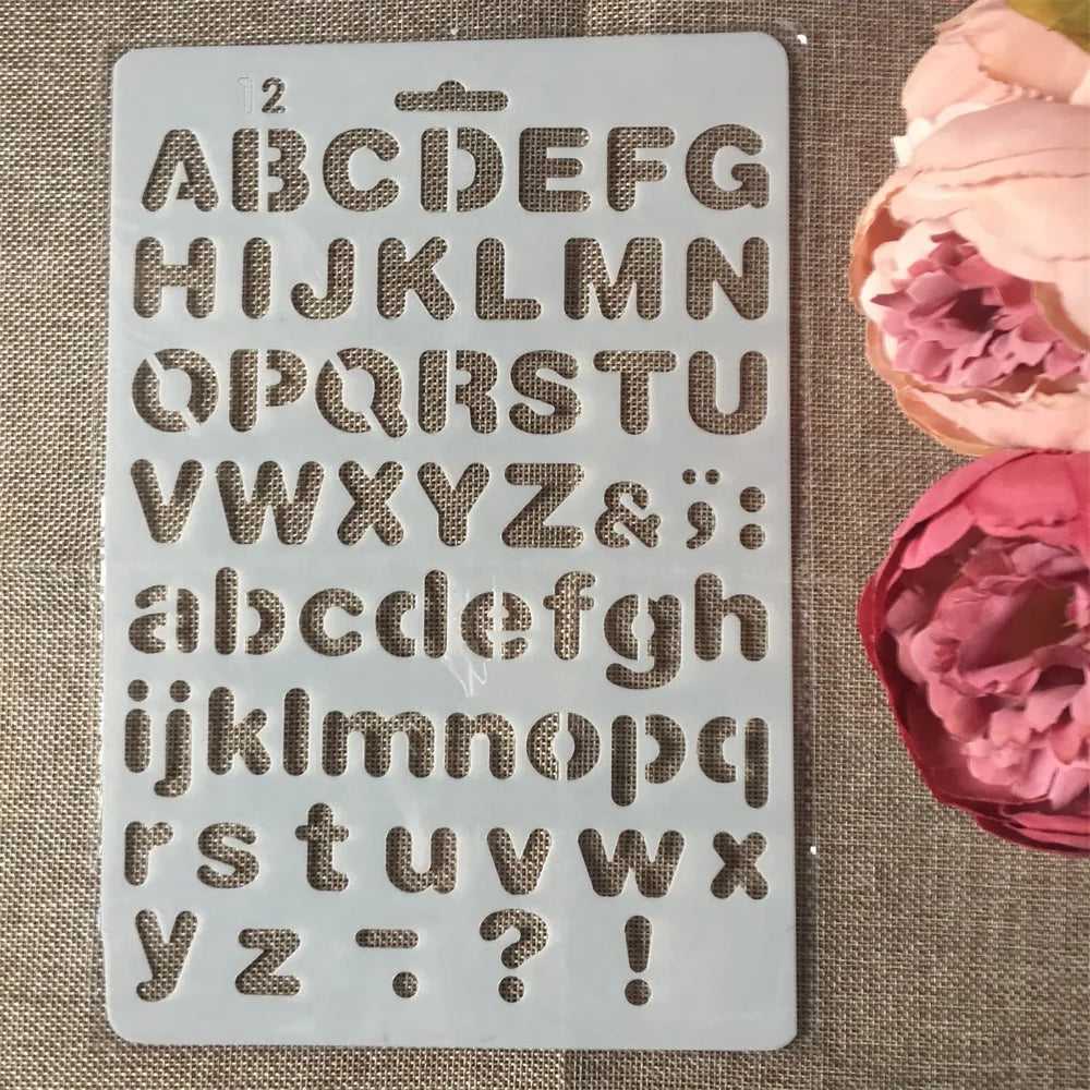 A white stencil sheet showing uppercase and lowercase letters, numbers, punctuation marks, and symbols for crafting.