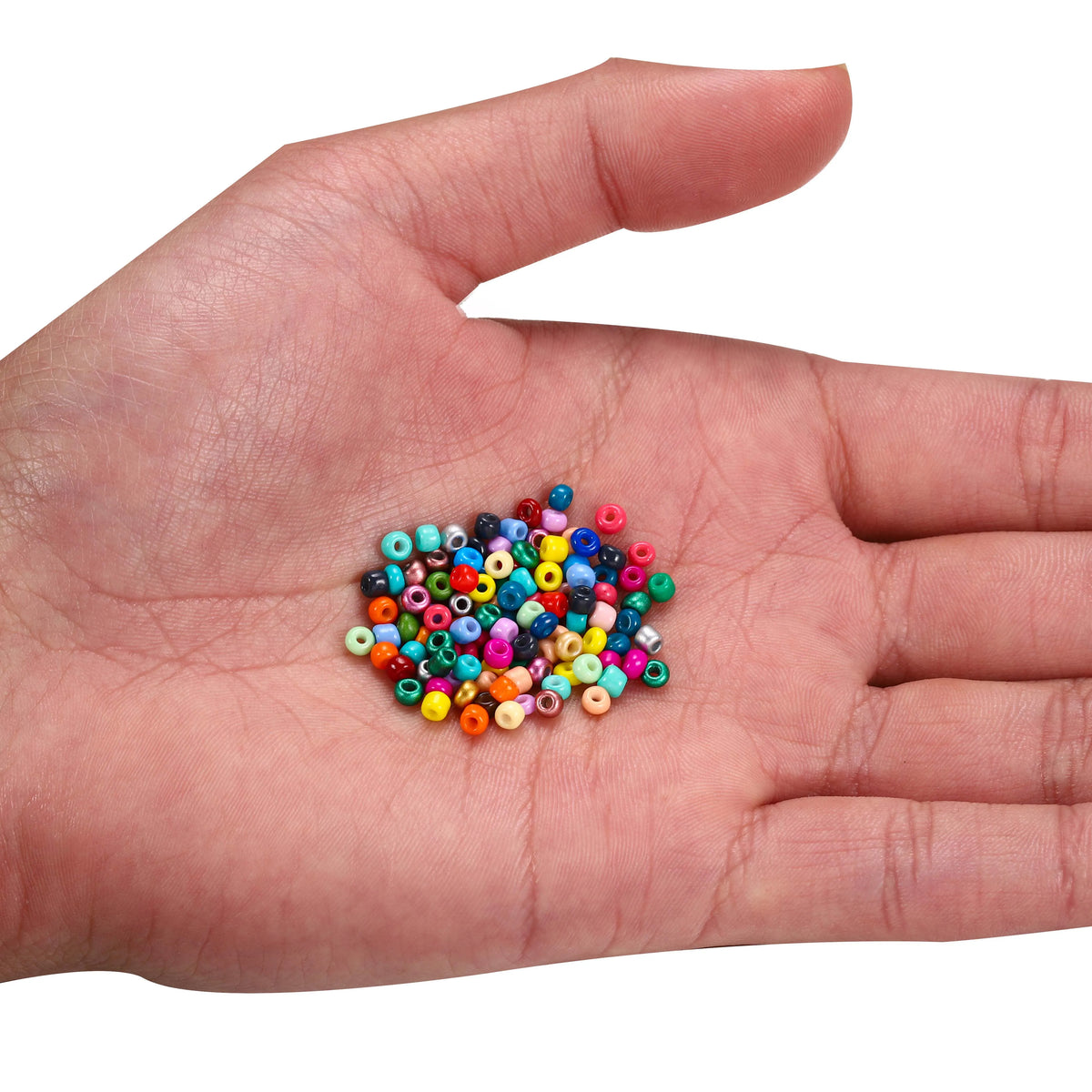 A hand holds a small pile of colorful round glass seed beads for jewelry making
