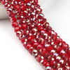 A close-up shot of red faceted crystal glass beads strung together for jewelry making