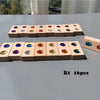 A set of 16 wooden gemstone building blocks with acrylic crystals arranged in two rows on a gray surface.