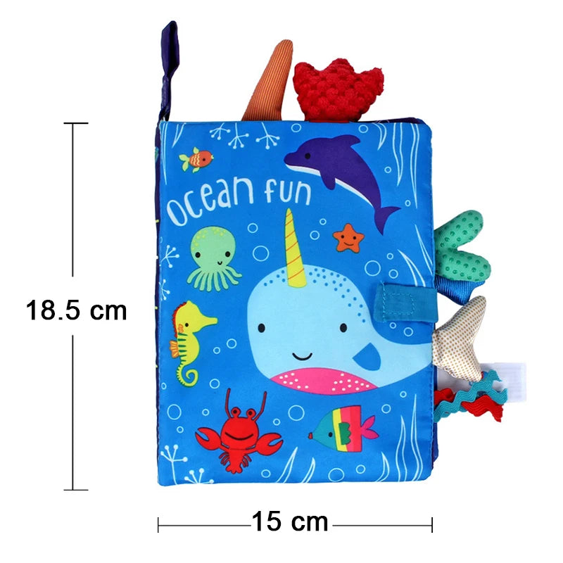 A blue cloth book featuring various colorful sea animals and a unicorn for baby sensory development.