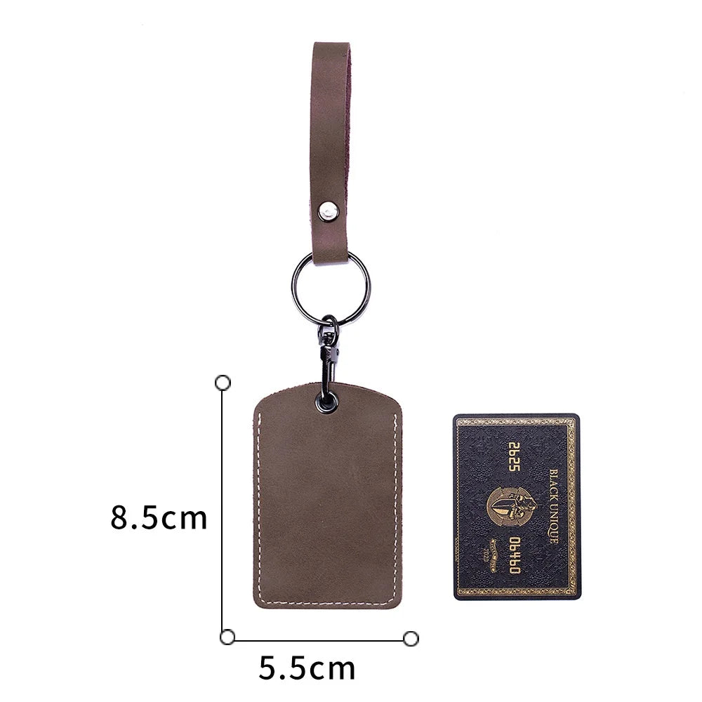 A brown leather key wallet with a card holder and a matching leather strap.