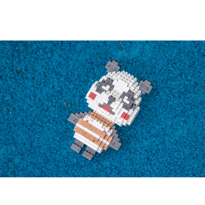 A small model of a panda made from white and gray building blocks resting on a blue surface.