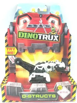 A Dinotrux dinosaur truck toy car with removable dinosaur figures displayed in its packaging.