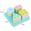A set of colorful wooden Montessori sensory blocks with music rattles arranged on a light blue base.