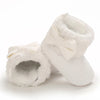 White plush baby snow boots for girls and boys with a bow detail