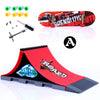 A finger skateboard park set featuring a red ramp and a wooden board with various hardware components.