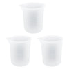 A set of clear reusable silicone resin mixing tools including measuring cups and stir sticks.