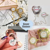 A set of baby pacifiers and clips with rhinestone accents in gold and silver tones.