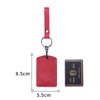 A red leather key wallet with a card holder and a matching strap, shown against a white background.