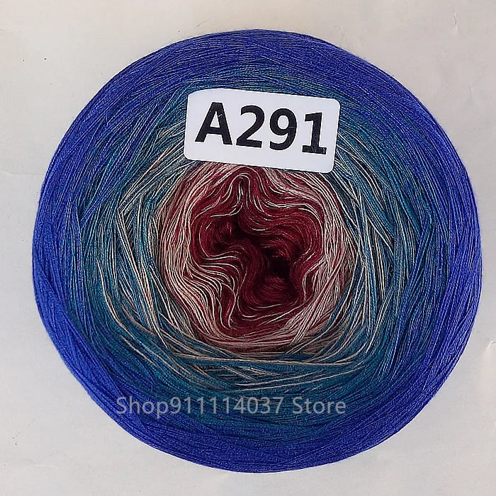 A spool of A291 cake yarn showing a rainbow gradient color transition.